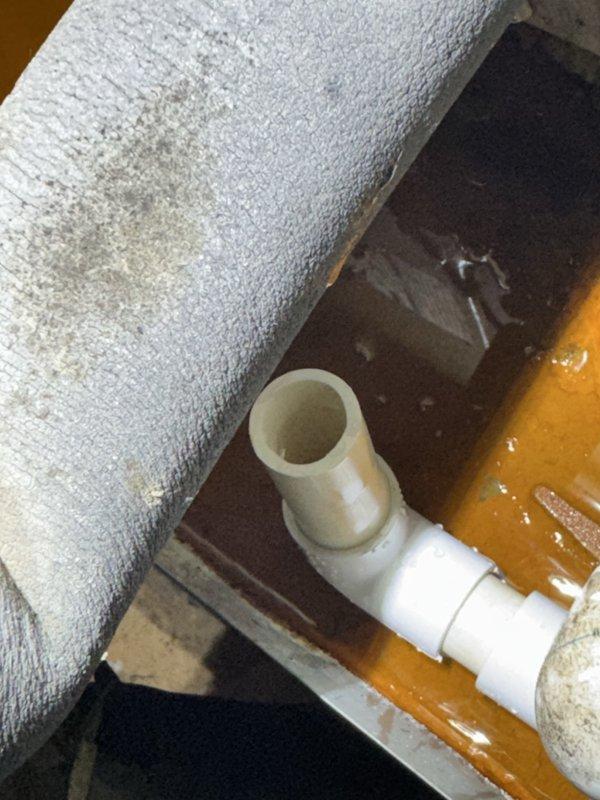 Performed diagnostic on a 2015 unit reported as not cooling with non-operational fan. Inspection revealed water pooling around the system with rust-colored liquid accumulating at the base and significant staining on insulated components. Visual examination of the filter/ventilation system showed dust accumulation but no visible damage to the mechanical components.