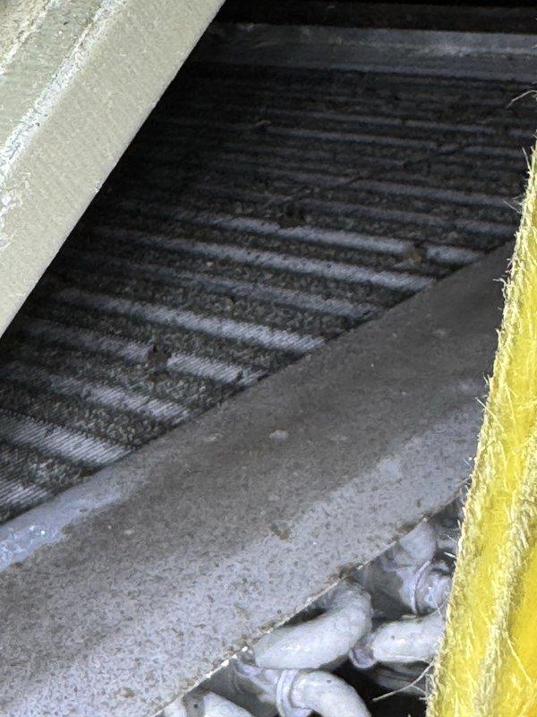 Performed diagnostic on a 2015 unit reported as not cooling with non-operational fan. Inspection revealed water pooling around the system with rust-colored liquid accumulating at the base and significant staining on insulated components. Visual examination of the filter/ventilation system showed dust accumulation but no visible damage to the mechanical components.