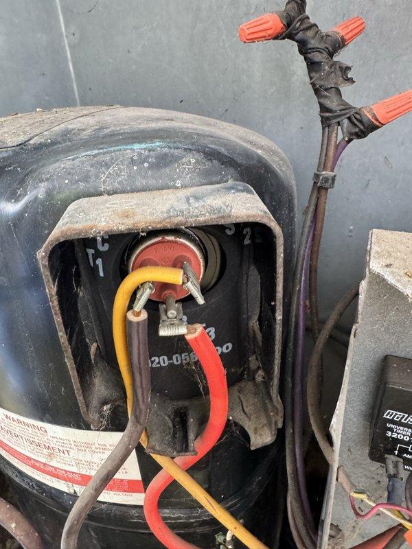 Performed diagnostic on AC system that was blowing air but not cooling. Inspected capacitor and compressor electrical connections, finding multiple wires with visible wear. Identified capacitor failure as the source of cooling issue and replaced component to restore proper system operation.