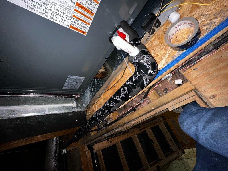 Completed full system installation consisting of indoor air handler unit in utility space and outdoor Amana condensing unit. Indoor work included mounting equipment on wooden joists, installing insulated refrigerant lines, and completing all necessary electrical connections. Outdoor unit was properly positioned on brick surface with line set connected to indoor components for a complete operational HVAC system.