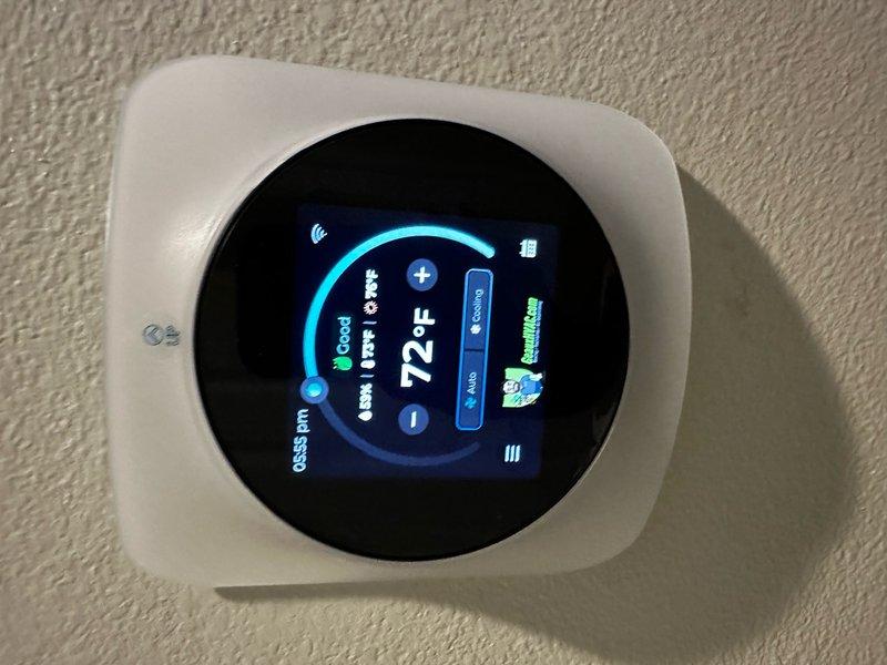 Successfully installed a new Carrier 4-ton economy gas system. Properly positioned outdoor condenser unit on concrete pad adjacent to the home's exterior wall with electrical connections secured. Installed and configured digital programmable thermostat, confirming proper system operation with temperature set at 72°F in auto mode.