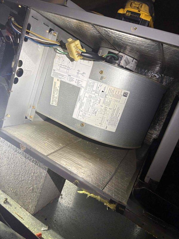 Performed routine HVAC maintenance and inspection on vacant property between tenant occupancy. Accessed attic-mounted system, cleaned equipment components, and inspected horizontal air handler unit with associated ductwork and mounting hardware. Identified significant frost and ice accumulation along ductwork seams and metal panel junctions, indicating potential condensation issues or insulation concerns that may require monitoring or future attention.