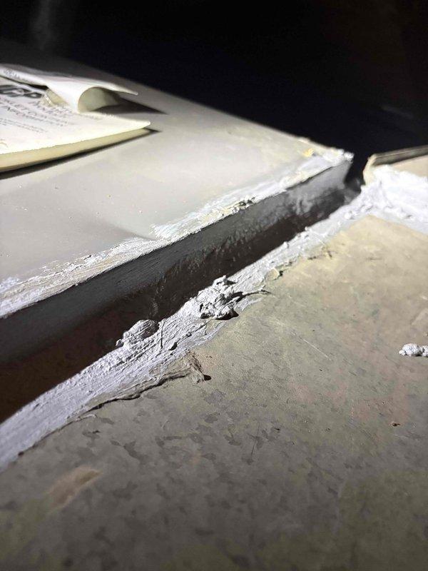 Performed routine HVAC maintenance and inspection on vacant property between tenant occupancy. Accessed attic-mounted system, cleaned equipment components, and inspected horizontal air handler unit with associated ductwork and mounting hardware. Identified significant frost and ice accumulation along ductwork seams and metal panel junctions, indicating potential condensation issues or insulation concerns that may require monitoring or future attention.