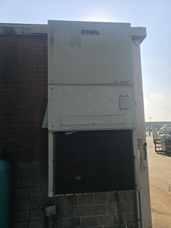 Assessed non-functional wall-mounted HVAC unit serving training room area. Documented existing Harv Air outdoor condensing unit with weathered exterior cabinet showing significant dirt accumulation and discoloration. Reviewed unit specifications including 208/230 VAC outdoor air motor and compressor electrical parameters. Provided replacement quote for failed equipment.