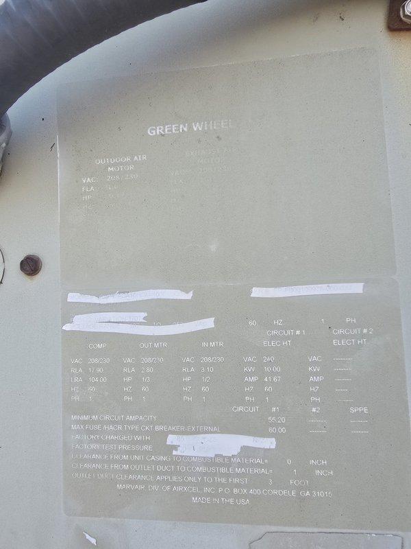 Assessed non-functional wall-mounted HVAC unit serving training room area. Documented existing Harv Air outdoor condensing unit with weathered exterior cabinet showing significant dirt accumulation and discoloration. Reviewed unit specifications including 208/230 VAC outdoor air motor and compressor electrical parameters. Provided replacement quote for failed equipment.
