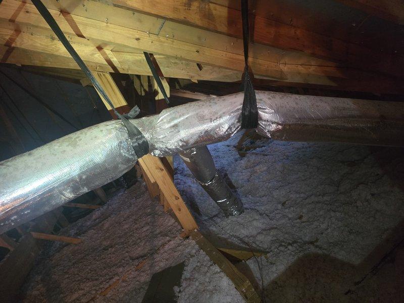 Conducted estimate revisit to verify HVAC system sizing and ductwork compatibility in attic space. Documented existing flexible ductwork installation, including insulated supply ducts, plenum connections, and current insulation conditions. Photographed system configuration to confirm specifications for equipment replacement recommendations.