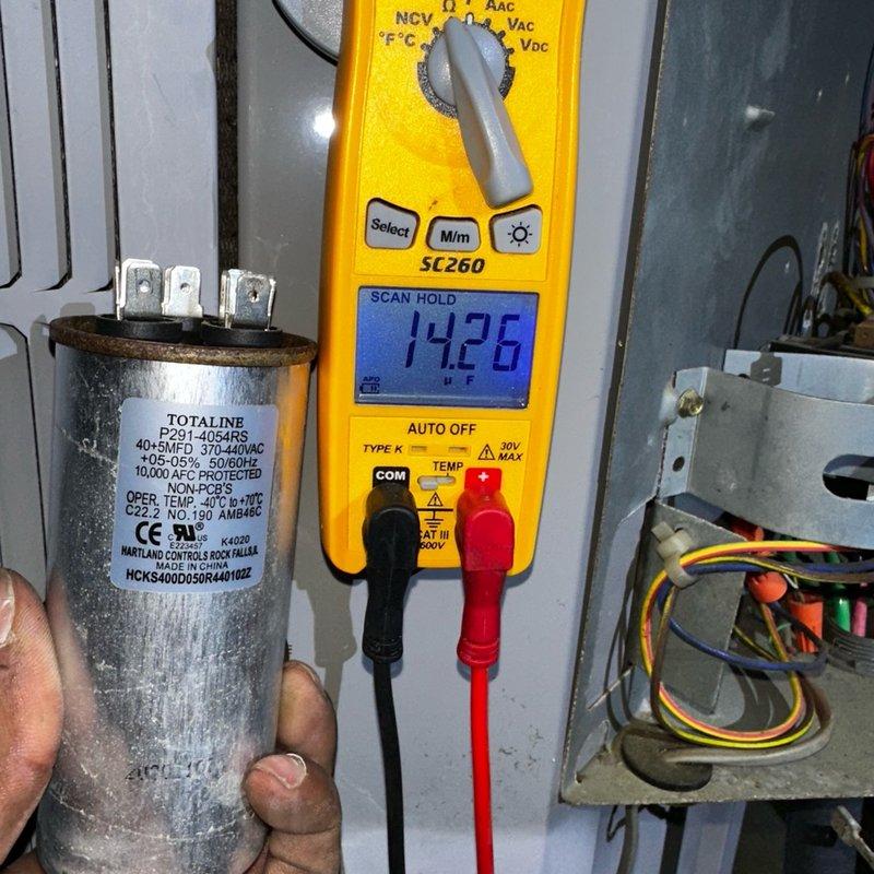 Responded to callback for back bedroom unit experiencing humming noise and cycling on/off following previous day's service. Upon arrival, performed diagnostic testing on system components. Tested dual-run capacitor (TOTALINE P291-4054RS, 40+5 MFD 370-440VAC) using digital multimeter, which revealed failed capacitor reading of 142.6 microfarads, significantly below manufacturer specifications. Inspected Copeland Scroll compressor (Model ZPS30KAE-PFV-130, R-410A) and associated electrical connections. Replaced defective capacitor to restore proper compressor operation and eliminate humming noise and short-cycling condition. Verified all electrical connections secure and system operating within normal parameters. Unit tested and confirmed operating properly with no abnormal sounds or cycling issues.