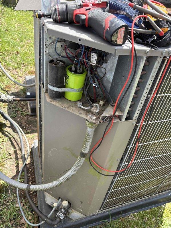 # Diagnostic - AC Issue

Responded to no cooling complaint on upstairs unit in two-system home. Upon arrival, confirmed compressor was running but condenser fan motor failed to operate. Removed access panel and performed electrical diagnostics on outdoor unit. Testing revealed faulty fan motor and defective capacitor preventing fan operation. Documented unit condition with photos showing internal electrical components, capacitor, and refrigerant lines. Provided customer with repair recommendations for fan motor replacement and capacitor replacement to restore cooling functionality to upstairs system.