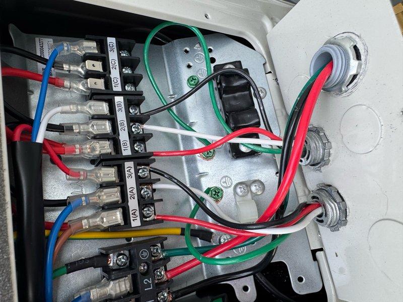 Responded to service call reporting freezing lines on two circuits and no cooling in women's restroom. Upon arrival, accessed rooftop unit and performed system inspection. Found electrical control panel and terminal connections in working order. Inspected wiring configuration, terminal blocks, and control board assembly. All electrical connections were secure with proper wire terminations at junction points. Control board displayed normal operation with LED indicators functioning correctly. Documented electrical panel configuration and wiring arrangement for warranty records. System components including terminal blocks, circuit board, and panel enclosure showed no signs of damage or deterioration.