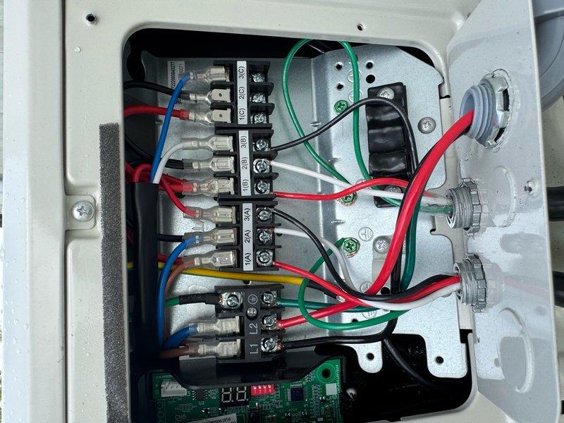 Responded to service call reporting freezing lines on two circuits and no cooling in women's restroom. Upon arrival, accessed rooftop unit and performed system inspection. Found electrical control panel and terminal connections in working order. Inspected wiring configuration, terminal blocks, and control board assembly. All electrical connections were secure with proper wire terminations at junction points. Control board displayed normal operation with LED indicators functioning correctly. Documented electrical panel configuration and wiring arrangement for warranty records. System components including terminal blocks, circuit board, and panel enclosure showed no signs of damage or deterioration.