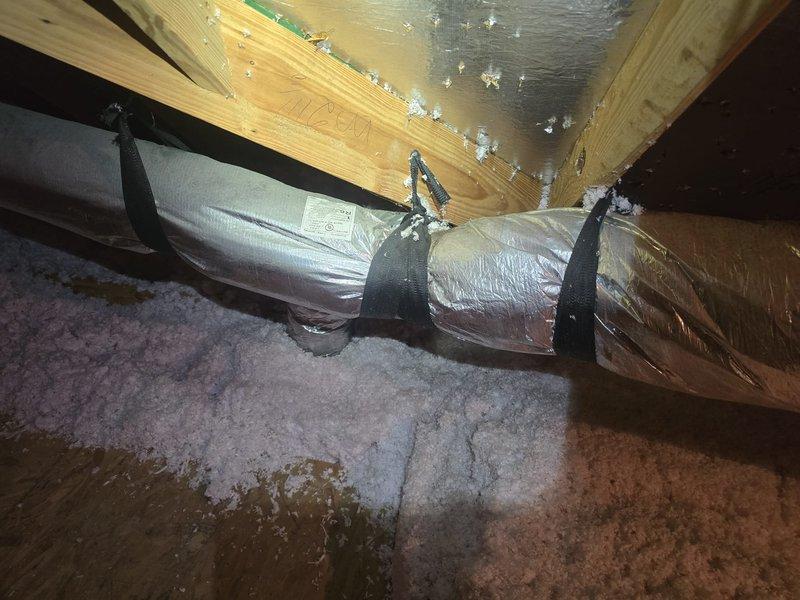 Completed installation of flexible ductwork system in attic space, including proper routing of insulated ducts through roof framing and securing with appropriate straps and fasteners. All ductwork was installed per specifications with reflective insulation material and is ready for system connection once the plenum is retrieved from the supplier.