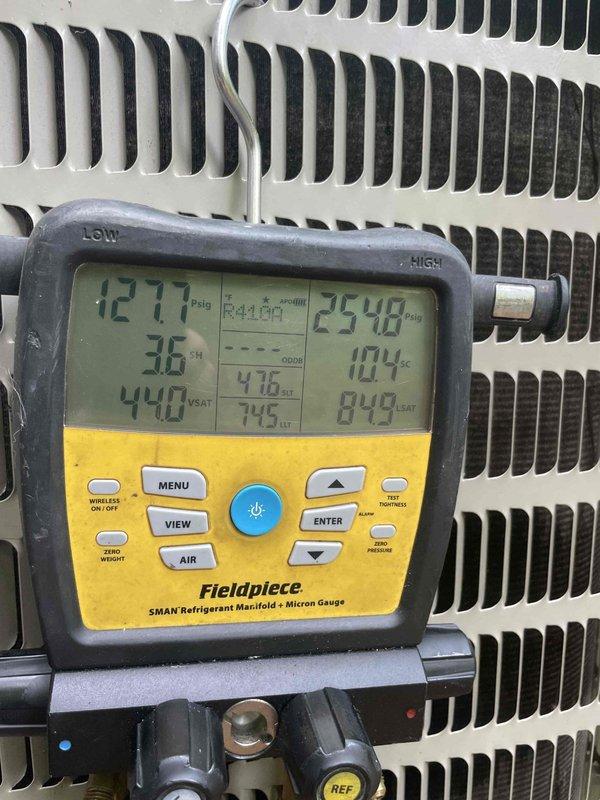 Completed spring preventative maintenance on HVAC system. Performed refrigerant pressure and temperature diagnostics using digital manifold gauge, recording operating pressures of 127 psia on low side and 254 psia on high side with corresponding temperatures of 36°F and 104°F. Inspected air handler unit in crawl space, verified proper operation of equipment, and confirmed adequate insulation materials present. Condenser unit coils found clean with no debris accumulation.