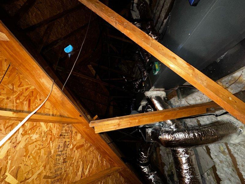 # Ductwork Replacement and System Diagnostics

Completed full ductwork replacement in attic space, including installation of specialty transition fittings to ensure proper airflow distribution throughout the residence. Removed old ductwork and installed new flexible duct runs with metallic silver insulation wrapping, properly securing all connections to the air handler unit. All ductwork was sealed and insulated to manufacturer specifications to prevent air leakage and maintain system efficiency.

Addressed homeowner concern regarding continuous system operation beyond thermostat set point. Performed diagnostic testing on thermostat control system and HVAC unit to identify potential malfunction causing unit to run continuously without cycling off when reaching desired temperature. Inspected thermostat wiring, control board connections, and system operation parameters. Verified proper communication between thermostat and outdoor condensing unit positioned on concrete pad at exterior loc