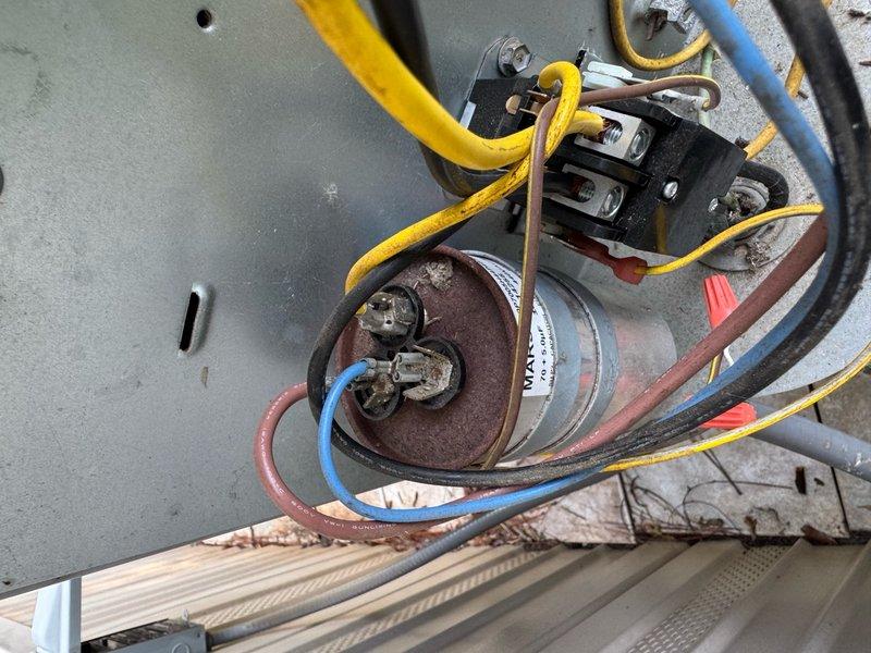 Responded to no cooling call where outdoor unit failed to operate despite thermostat functioning properly. Upon inspection, discovered failed run capacitor preventing compressor and condenser fan motor from starting. Removed defective capacitor and installed new replacement unit with proper microfarad rating. Verified all electrical connections secure, tested system operation, and confirmed outdoor unit now running normally with proper amp draw on both compressor and fan motor.
