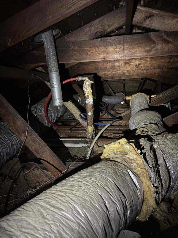 Completed return visit to vacant property following resolution of electrical issues. Replaced Schrader valve at evaporator coil, removed and replaced all deteriorated ductwork throughout attic space, and installed new 8" drop duct to service additional room. Verified evaporator coil is properly leveled and draining correctly to prevent future condensate issues.