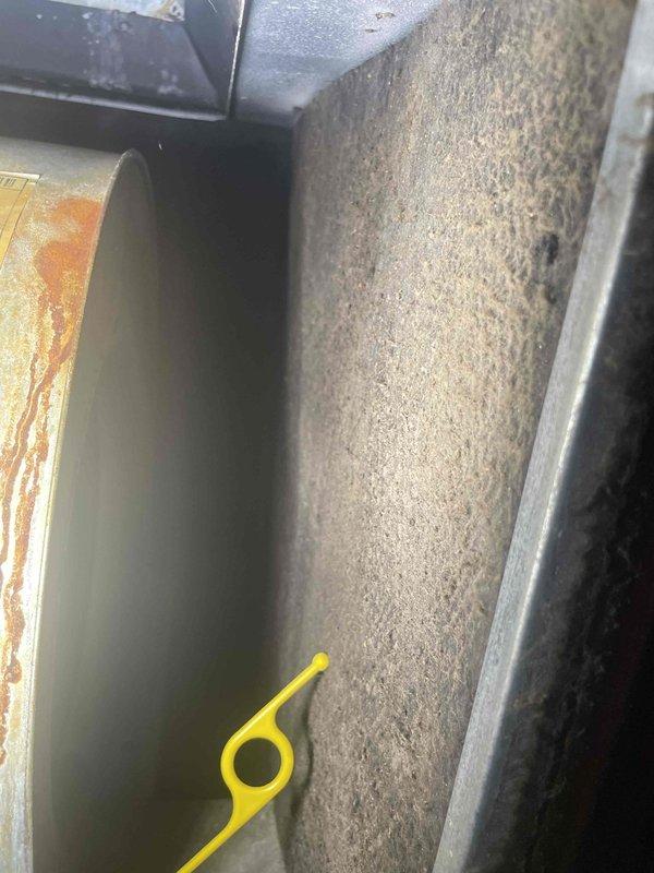 Responded to service call for electric AC unit experiencing freeze-up issues while still maintaining cooling capacity. Upon inspection, discovered heavily restricted airflow due to excessive dust and debris accumulation on the blower wheel assembly and interior components. The blower wheel blades exhibited significant matting of dust buildup, severely impacting system performance and causing the evaporator coil to ice over. Customer had turned unit off approximately two hours prior to allow defrosting. Documented condition of contaminated blower assembly and interior surfaces for service records. Recommended thorough cleaning of blower wheel, evaporator coil inspection once fully defrosted, and air filter evaluation to restore proper airflow and prevent future freeze-up conditions.