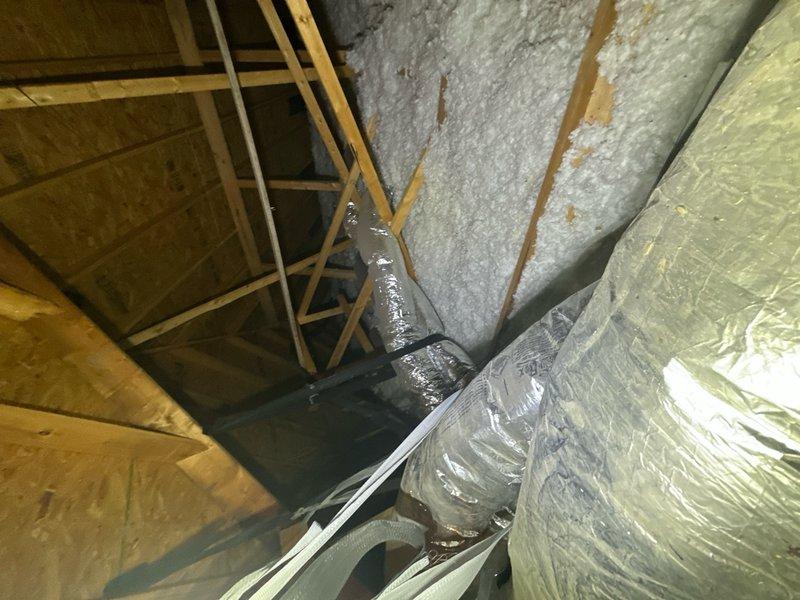 Completed spring maintenance inspection of attic space and HVAC system components. Inspected access hatch structure, verified proper installation and hardware function, examined blown-in insulation coverage and depth throughout attic floor, and assessed flexible ductwork routing and connection integrity. All spray foam insulation applications between rafters were checked for proper adhesion and coverage, vapor barrier materials were confirmed to be properly positioned, and overall attic ventilation and structural framing were evaluated for any maintenance concerns.