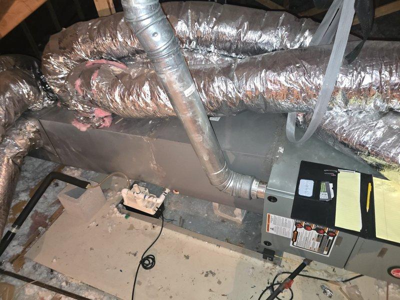 Conducted comprehensive assessment of existing HVAC system located in attic space. Evaluated current air handler unit, ductwork configuration, and overall system condition. Documented deteriorating flexible ductwork with compromised outer coverings exposing internal insulation, multiple branch connections showing wear and discoloration, and equipment positioning on platform. Provided detailed estimate for complete system replacement including new air handler installation and ductwork modifications to address observed deficiencies and improve system performance.
