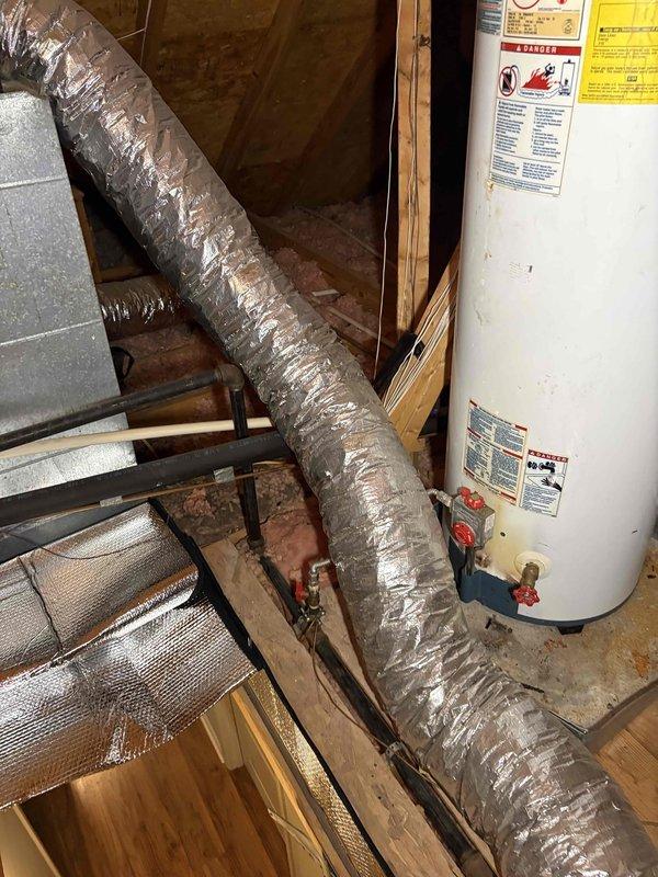 Completed annual cooling maintenance on residential HVAC system. Inspected air handler unit in attic space, verified proper operation of all mechanical components, and checked ductwork connections for secure attachment and adequate insulation integrity. Examined condensate drain line assembly with PVC piping, confirmed proper drainage flow and trap configuration to prevent system overflow. All equipment found operating within normal parameters with no immediate service needs identified.