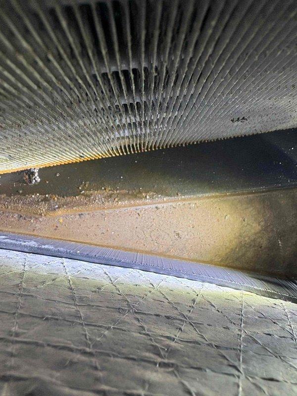 Performed comprehensive second opinion diagnostic on 4-ton electric AC unit experiencing cooling issues and system freezing. Conducted thorough system inspection including visual examination of evaporator coil, blower assembly, and air handler components. Assessed multiple concerns reported by previous service providers including capacitor failure, refrigerant loss, blower malfunction, and potential coil replacement needs. Documented significant dust and debris accumulation within air handler and ductwork system. Evaluated system airflow, refrigerant pressures, and electrical components to determine root cause of inadequate cooling and freeze-up condition on 10-year-old residential HVAC system.