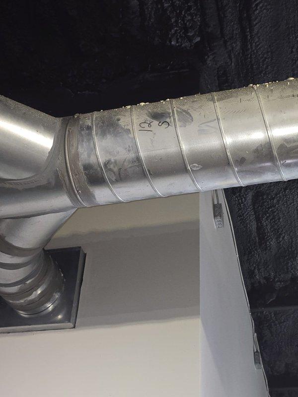 Completed estimate for installation of three ductless mini-split systems in commercial conference rooms. Assessed requirements for 1-ton, 1.5-ton, and 2-ton capacity units based on room specifications. Photographed existing HVAC infrastructure including attic-mounted air handler with flexible ductwork and basement ductwork routing to determine optimal placement for new mini-split indoor and outdoor units.