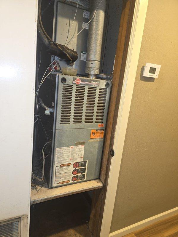 Provided estimate for complete HVAC system replacement on existing 20-year-old Rheem furnace and air conditioning unit. Current system remains operational but requires replacement to satisfy home sale contingency requirements. Assessed existing upflow gas furnace installation in utility closet, ductwork configuration, electrical connections, and condensing unit location to determine scope of replacement work.