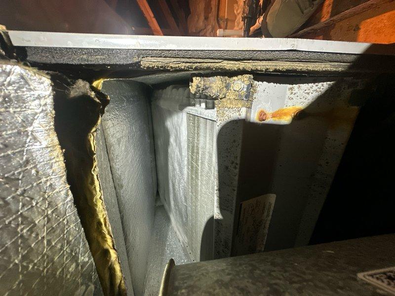 Responded to AC system blowing warm air following previous frozen evaporator coil issue. Performed diagnostic inspection of indoor air handler and evaporator coil assembly in attic space. Verified outdoor condensing unit operational status and confirmed refrigerant lines no longer frozen with no water present in condensate pan. Assessed system airflow, refrigerant charge levels, and overall HVAC component condition to determine root cause of inadequate cooling performance and provided repair estimate for necessary corrective actions.
