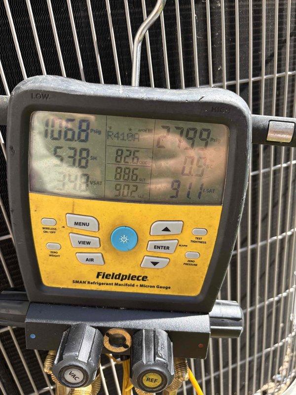 Performed diagnostic evaluation of HVAC system refrigerant levels and electrical components. Utilized Fluke 325 True RMS clamp meter to verify electrical current draw, measuring 9.70 amps at the condensing unit. Connected Fieldpiece SMAN refrigerant manifold gauge to system, recording operating pressures and monitoring refrigerant charge. System analysis indicated low refrigerant levels requiring additional charge to restore proper operating parameters and optimize cooling performance.