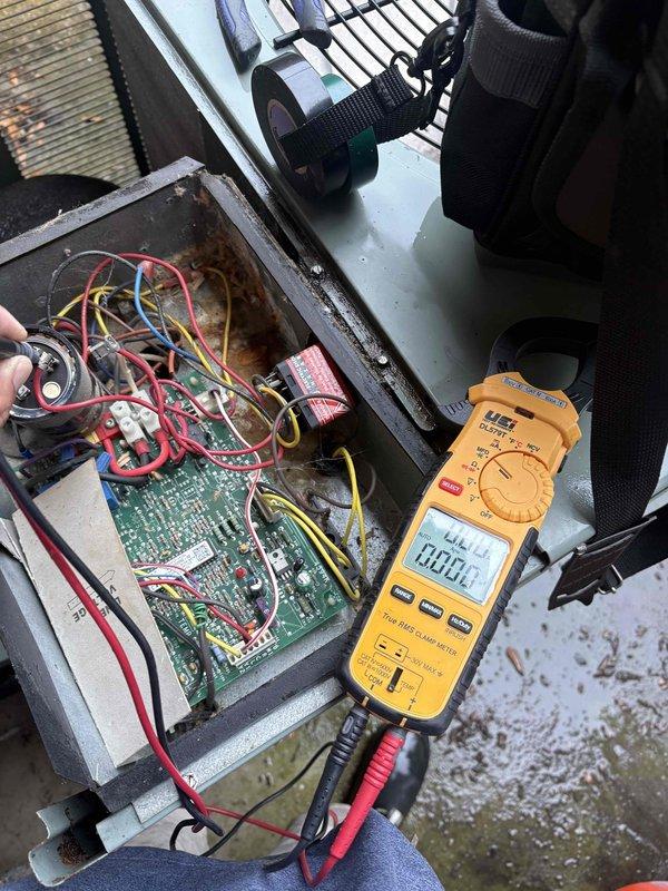 Performed comprehensive AC system cleaning and inspection. Removed access panel to examine electrical control components, tested voltage and amperage readings using digital multimeter to verify proper system operation, and utilized refrigerant manifold gauge to measure system pressures and temperatures across all zones. Interior components showed minor corrosion on housing which was noted for monitoring, wiring connections were inspected and found secure, and all electrical readings confirmed system operating within normal parameters.