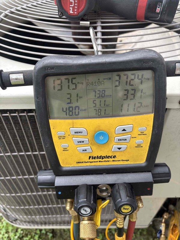 Responded to no cooling complaint on residential AC system approximately 4 years old. Upon inspection, found evaporator coil completely frozen with extensive ice buildup throughout air handler cabinet. System history indicates refrigerant additions in 2021 and 2023, plus capacitor replacement in 2023, suggesting chronic refrigerant leak losing charge approximately every two years. Verified low refrigerant pressures using manifold gauges, with suction pressure reading 31°F and abnormal system temperatures confirming undercharge condition. Documented frozen coil condition with photographic evidence showing severe frost accumulation on evaporator and surrounding surfaces. Recommended system leak detection and repair to address underlying issue causing repeated refrigerant loss rather than continued recharging.
