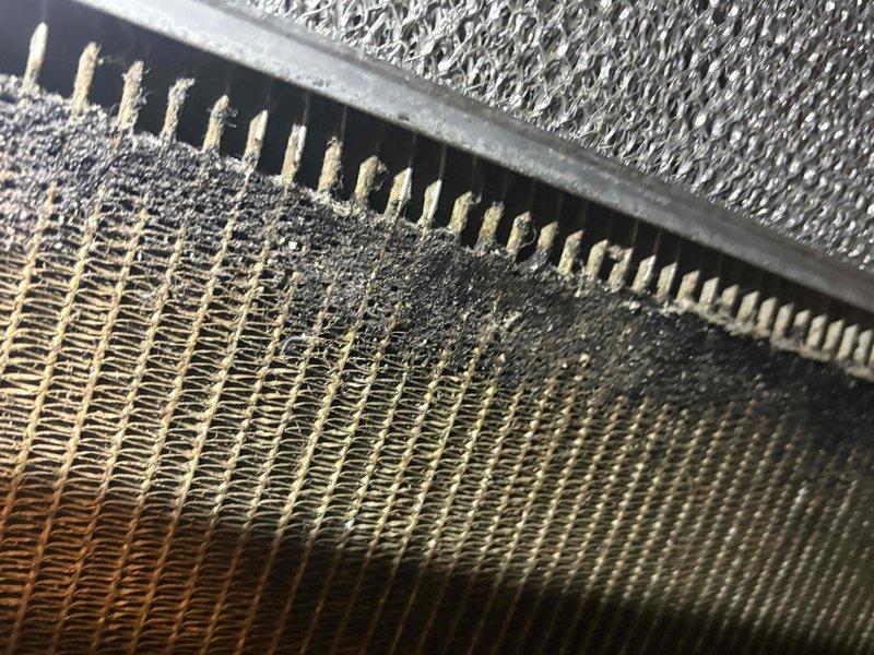 # AC Maintenance Service Completed

Performed comprehensive cleaning and inspection on single-system air conditioning unit as part of routine membership maintenance. Upon initial assessment, discovered significant contamination on evaporator coil assembly, including heavy accumulation of dirt, dust, and debris along the fin surfaces and base panels. Dark discoloration and caked buildup were evident in lower sections and crevices where fins meet the housing frame, indicating extended period without proper maintenance.

Conducted thorough coil cleaning to remove all contaminants and restore optimal heat transfer efficiency. Inspected condenser coil fins for damage and proper alignment. Documented pre-cleaning conditions showing contrast between contaminated and clean coil sections. All components returned to proper operating condition. System now operating at manufacturer specifications with improved airflow and heat exchange capability.