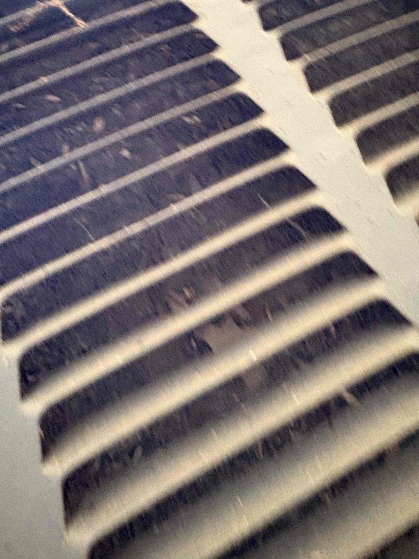 Responded to service call for air conditioning unit experiencing repeated freeze-up conditions. Upon arrival, confirmed unit was currently frozen and explained that diagnostic testing and repairs cannot be performed until system is completely thawed. Documented significant dust and debris accumulation on return air grilles, which restricts airflow and is a common contributing factor to evaporator coil freezing. Instructed customer to turn off cooling mode and run fan-only operation to facilitate thawing process. Photographed heavily soiled return vents showing substantial buildup on louvers and slats. Recommended filter replacement and return vent cleaning as immediate steps once system thaws, as restricted airflow is primary cause of freeze-up issues in residential HVAC systems.