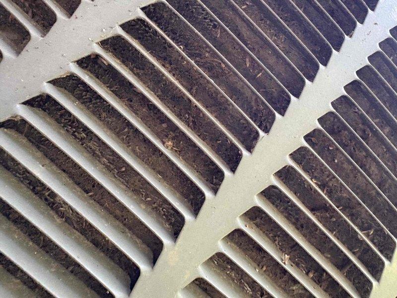 Responded to service call for air conditioning unit experiencing repeated freeze-up conditions. Upon arrival, confirmed unit was currently frozen and explained that diagnostic testing and repairs cannot be performed until system is completely thawed. Documented significant dust and debris accumulation on return air grilles, which restricts airflow and is a common contributing factor to evaporator coil freezing. Instructed customer to turn off cooling mode and run fan-only operation to facilitate thawing process. Photographed heavily soiled return vents showing substantial buildup on louvers and slats. Recommended filter replacement and return vent cleaning as immediate steps once system thaws, as restricted airflow is primary cause of freeze-up issues in residential HVAC systems.