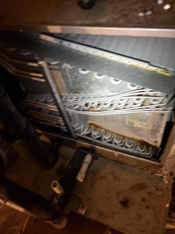 Completed comprehensive AC maintenance inspection and cleaning for single-system residential unit. Performed electrical diagnostics using clamp meter to verify proper amperage draw and system performance at condenser unit. Inspected evaporator coil assembly and heat exchanger components, confirming adequate airflow through fins and proper refrigerant line connections.