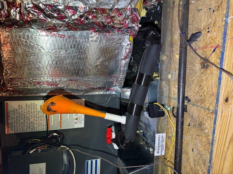 Responded to callback for newly installed HVAC unit leaking into ceiling. Upon inspection in attic space, discovered condensate drainage issue related to corroded drain fitting. The existing drain pipe showed extensive rust and deterioration, compromising the seal and allowing water to escape from the condensate system. Addressed the leak by securing the condensate pump connections and verifying proper drainage flow from the new air handler. Documented installation conditions including ductwork insulation, electrical connections, and structural mounting points for quality assurance records.