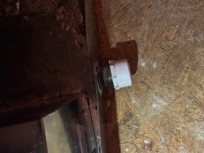 Responded to callback for newly installed HVAC unit leaking into ceiling. Upon inspection in attic space, discovered condensate drainage issue related to corroded drain fitting. The existing drain pipe showed extensive rust and deterioration, compromising the seal and allowing water to escape from the condensate system. Addressed the leak by securing the condensate pump connections and verifying proper drainage flow from the new air handler. Documented installation conditions including ductwork insulation, electrical connections, and structural mounting points for quality assurance records.