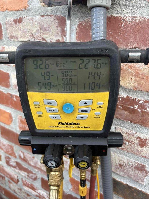 Responded to service call for downstairs AC unit not cooling adequately, with thermostat set at 72°F but unable to maintain temperature below 74°F. Performed comprehensive diagnostic evaluation of the system using professional HVAC testing equipment. Utilized Fieldpiece SMAN refrigerant manifold with micron gauge to measure system pressures and temperatures, recording readings of 926 PSI low side and 2216 PSI high side, with corresponding temperatures of 49°F and 144°F. Deployed Elitech LMC-100A+ digital measuring instrument to assess additional system parameters and refrigerant charge levels. Conducted thorough inspection of outdoor condensing unit components and verified refrigerant line connections. Documented equipment conditions and diagnostic readings through photographic evidence for service records. Provided customer with findings from diagnostic assessment and discussed system performance concerns. Customer expressed interest in receiving estimates for complete system replacem