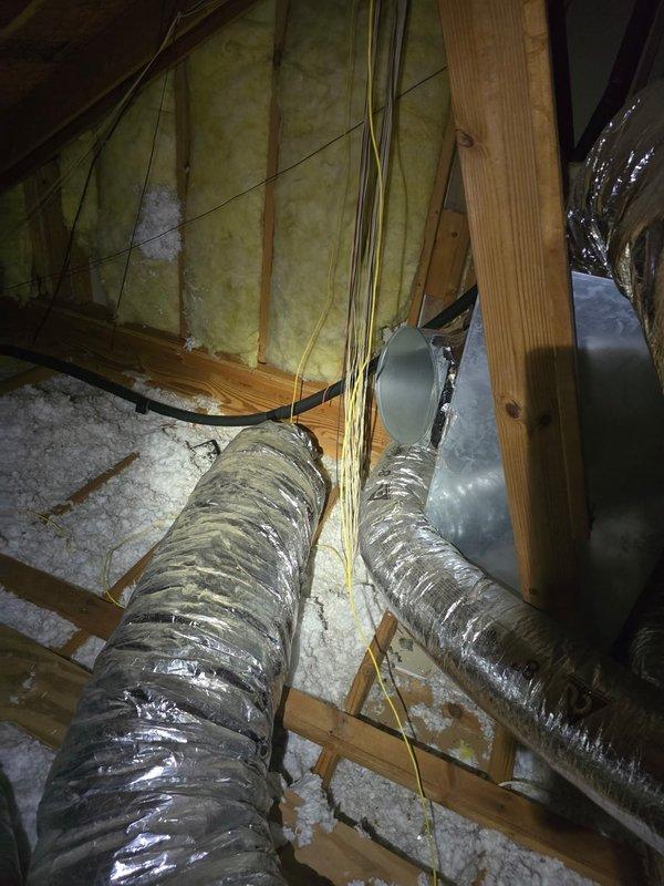 Reattached flexible aluminum supply duct that had become disconnected in the attic space. The duct was properly secured back to the HVAC plenum junction point and fastened with appropriate strapping to ensure proper airflow to the designated zone. Verified all connections were tight and ductwork was properly supported to prevent future disconnection.
