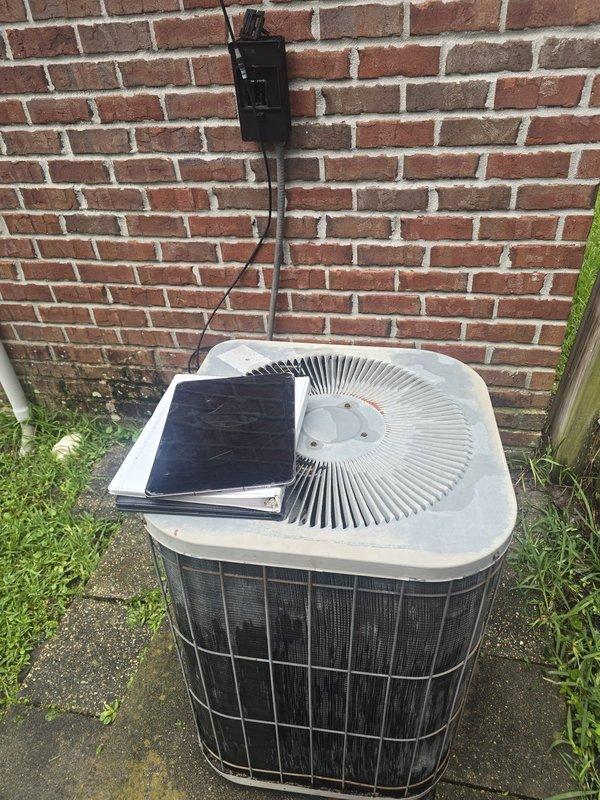 Performed comprehensive second opinion evaluation of outdoor condensing unit positioned on concrete pad. Documented existing 32-year-old system configuration with detailed photographic assessment of unit condition, including two-tone cabinet construction with protective wire mesh guard, spiral fan grille assembly, wall-mounted electrical disconnect box, and associated conduit routing. Reviewed installation specifications and service history documentation to provide accurate estimate recommendations for system replacement considerations.