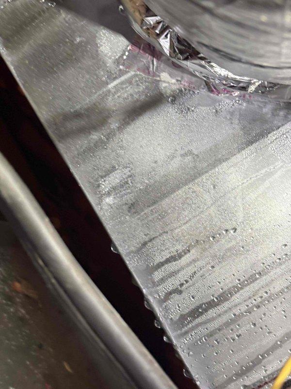 Completed comprehensive AC maintenance service including system cleaning and inspection as part of membership benefits. During inspection, observed significant condensation on flexible ductwork and air handler components, indicating proper system operation under current humidity conditions. Documented HVAC equipment condition with photographic evidence showing ductwork, insulation integrity, and normal moisture accumulation on metallic surfaces.
