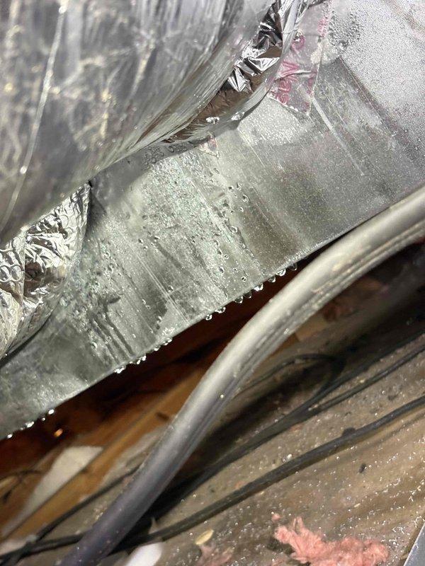 Completed comprehensive AC maintenance service including system cleaning and inspection as part of membership benefits. During inspection, observed significant condensation on flexible ductwork and air handler components, indicating proper system operation under current humidity conditions. Documented HVAC equipment condition with photographic evidence showing ductwork, insulation integrity, and normal moisture accumulation on metallic surfaces.