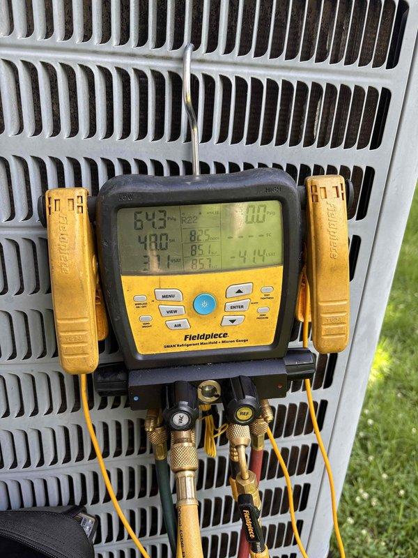 Responded to no cooling complaint on residential air conditioning system. Upon arrival, accessed attic-mounted air handler and outdoor condensing unit. Connected refrigerant manifold gauges to service ports and recorded system pressures and temperatures. Previous service history indicated recent compressor replacement with capacitor and hard start kit installation, along with UV dye injection for leak detection. Performed visual inspection of refrigeration lines, connections, and components in attic space. Evaluated system operating parameters using digital manifold gauge set to assess refrigerant charge and system performance. Documented findings with photographic evidence of equipment condition and diagnostic readings for further analysis and recommended follow-up leak search to verify system integrity.