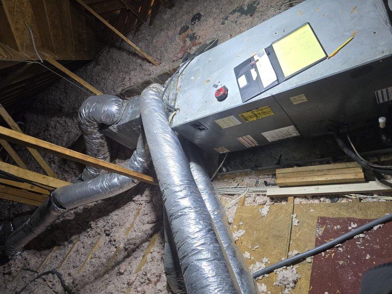 Conducted second opinion assessment of existing HVAC system installed in attic space. Inspected air handler unit and associated ductwork configuration for system evaluation. Documented current equipment condition including flexible duct connections, attic installation positioning, and overall system layout. Photographed equipment labels, ductwork routing, structural mounting, and surrounding attic conditions to support estimate preparation for new system installation. Assessment completed to provide technical information for proposed HVAC system replacement.