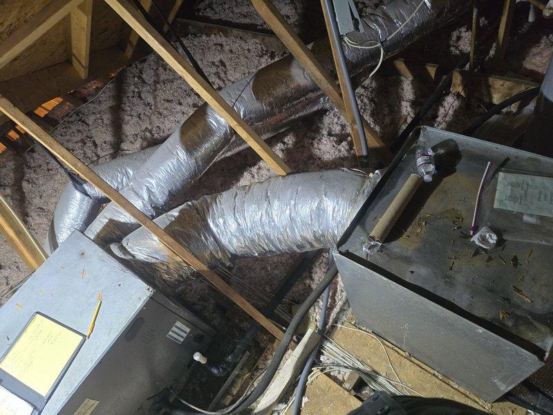 Conducted second opinion assessment of existing HVAC system installed in attic space. Inspected air handler unit and associated ductwork configuration for system evaluation. Documented current equipment condition including flexible duct connections, attic installation positioning, and overall system layout. Photographed equipment labels, ductwork routing, structural mounting, and surrounding attic conditions to support estimate preparation for new system installation. Assessment completed to provide technical information for proposed HVAC system replacement.