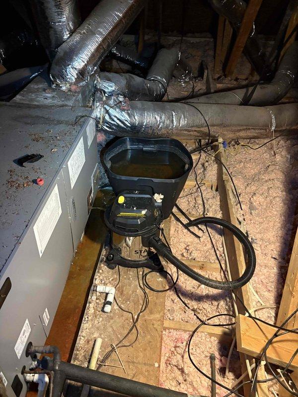 Responded to service call for recurring drain pan clogs on a 4-5 year old HVAC system. Performed diagnostic inspection of air handler unit located in attic space. Accessed equipment to assess condensate drainage system and identify cause of repeated blockages. Measured and documented system components and clearances. Inspected air handler, condensate pump assembly, and associated ductwork for proper operation and potential drainage issues. Evaluated installation configuration and equipment condition to determine appropriate corrective action for preventing future drain pan overflow.