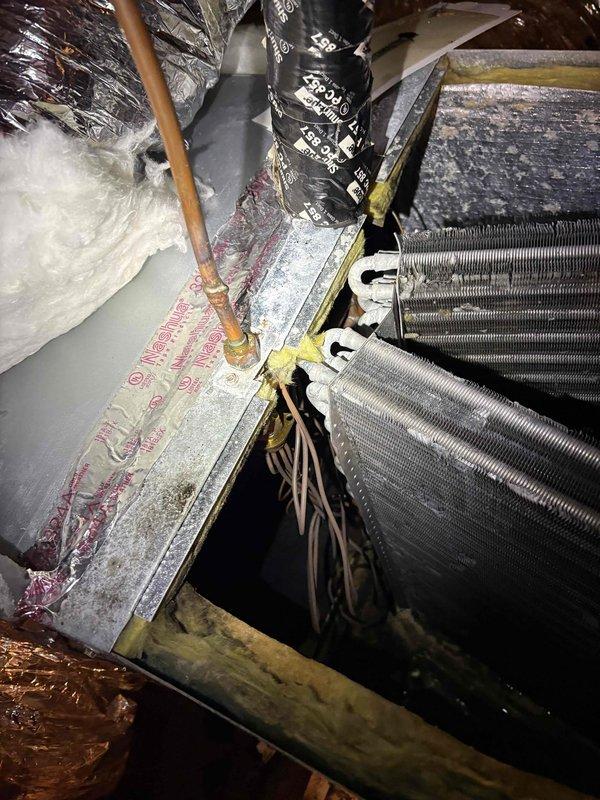 Completed spring maintenance on residential AC system. Upon inspection, found evaporator coil heavily coated with dust and debris accumulation throughout all fin sections, which was causing restricted airflow and contributing to the extended cooling times reported by customer. Performed thorough cleaning of evaporator coil, removing significant buildup from aluminum fins and housing. Verified proper refrigerant line connections and inspected all accessible system components in attic installation. System airflow restored to proper levels following coil cleaning, which should resolve the delayed temperature recovery issue.