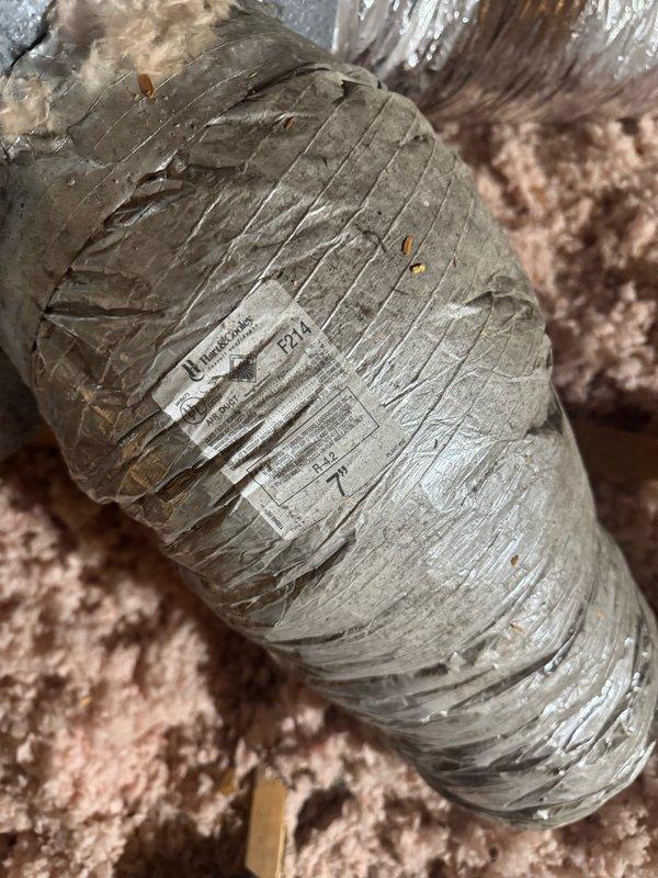 Responded to after-hours service call for cooling system not maintaining temperature, with thermostat set to 75°F but displaying 80°F on unit installed in 2023. Upon investigation, inspected HVAC ductwork system in attic space and identified compromised flexible ductwork with visible compression and bending that would restrict airflow. Documented conditions of installation including duct placement, insulation coverage, and overall system accessibility for further evaluation and repair recommendations.