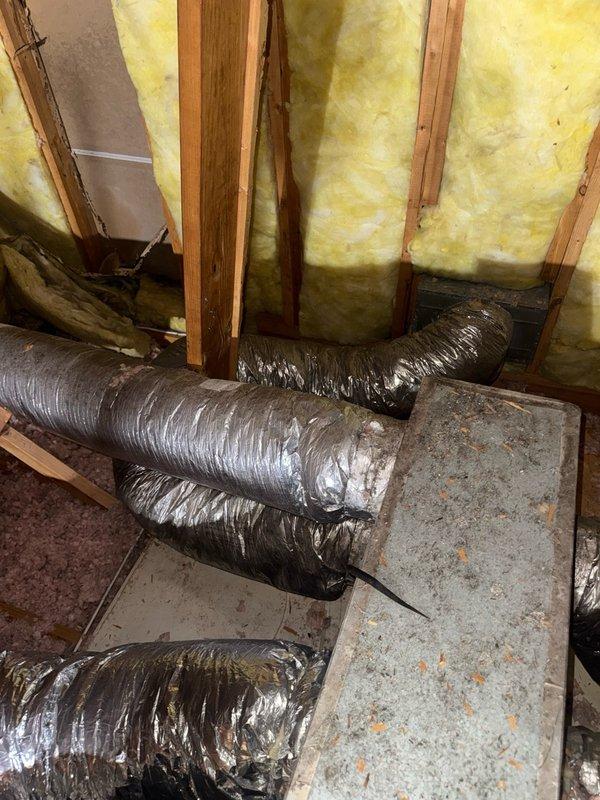 Responded to after-hours service call for cooling system not maintaining temperature, with thermostat set to 75°F but displaying 80°F on unit installed in 2023. Upon investigation, inspected HVAC ductwork system in attic space and identified compromised flexible ductwork with visible compression and bending that would restrict airflow. Documented conditions of installation including duct placement, insulation coverage, and overall system accessibility for further evaluation and repair recommendations.