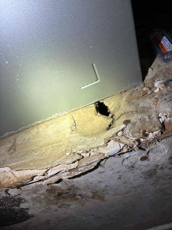 Responded to no cooling complaint with continuous fan operation. Upon arrival, found thermostat displaying 72°F setpoint with actual temperature reading of 89°F, indicating significant temperature differential and system failure to maintain desired cooling. Performed diagnostic inspection of HVAC system and identified severe water damage at air handler location with compromised insulation, deteriorated drywall, and moisture staining on surrounding surfaces. Documentation captured showing extensive structural damage affecting unit operation and performance. System requires immediate attention to address water intrusion source and damaged components preventing proper cooling cycle operation.