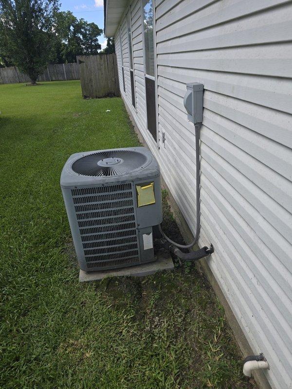 Completed installation of a 3.5-ton Amana electric HVAC system including outdoor condensing unit and indoor air handler. Outdoor unit was positioned on concrete pad with proper electrical disconnect and refrigerant line connections through exterior wall penetration. Indoor air handler was installed in attic space with flexible ductwork distribution system and new supply plenum connected to existing duct infrastructure.